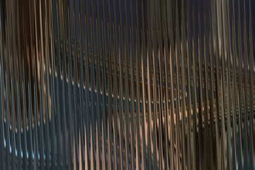 Abstract textured background with vertical wavy lines and blurred lights, creating a sense of depth and movement