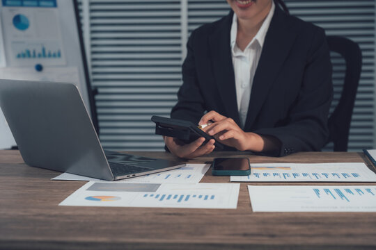 Business Professional at Work: A focused business professional, immersed in the task of financial analysis, using calculator. Capturing the essence of diligence and financial expertise. - Powered by Adobe