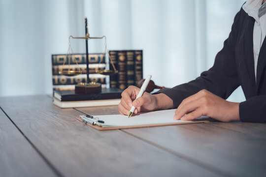 Legal Precision: A focused individual meticulously crafts a legal document at a professional workstation, capturing the essence of expertise and meticulous detail.