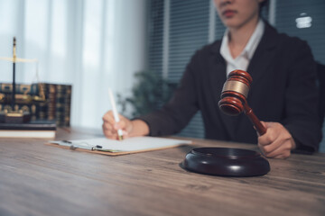 Justice in Session: A dedicated legal professional, seated at a polished desk, meticulously documents proceedings. Clutched in their grasp is a gavel, symbolizing authority.