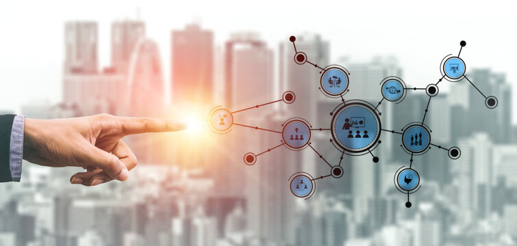 A businessman points at a digital network illustrating communication and collaboration icons over a blurred city backdrop, symbolizing modern business strategies and technology integration. Tessel - Powered by Adobe