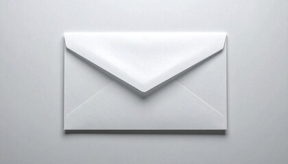 White envelope lying flat on a neutral surface in simple studio shot