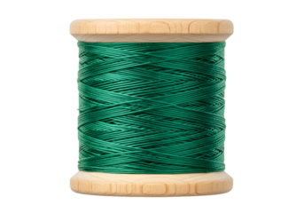 A close-up view of a spool of emerald green thread, wound tightly, resting on a light beige wooden base against a black backdrop.