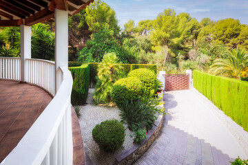View of the garden and entrance gate from the terrace of the house.