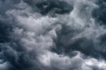 Stormy sky background with dramatic dark clouds during powerful thunderstorm in moody atmosphere