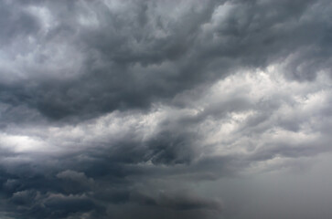 Dark cumulus storm clouds filling dramatic sky with intense atmosphere creating moody natural background for weather, climate, and powerful nature concepts
