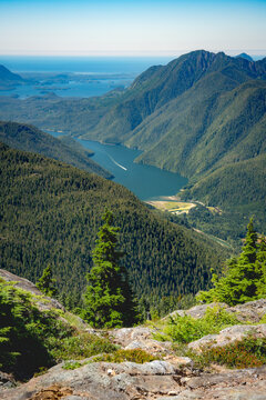 Looking down from a mountain top at a boat racing up a sound on west coast of Vancouver Island, Canada