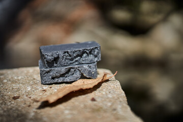 Handmade artisan black soap bars displayed on a natural stone surface. Organic, sustainable, and plant-based skincare made for holistic wellness and everyday purity