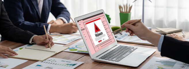 Cyber attacking concept. Malware alert showing on computer screen display scam and threat detection on computer system or online server to be removed brisk.