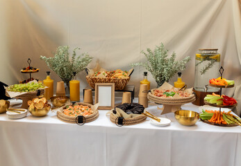 Gourmet catering spread displaying colorful appetizers, fresh beverages, elegant decorations for professional event styling and culinary presentation