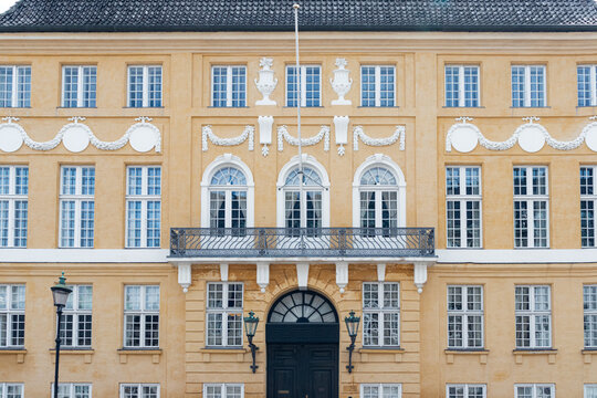 Copenhagen, Denmark- July 16, 2025: Yellow Palace (Bergum's Mansion) town mansion next to Amalienborg Palace in Frederiksstaden district building entrance