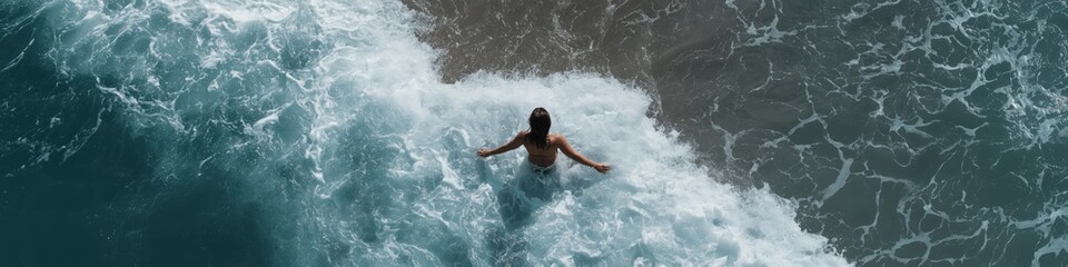 Aerial view of caucasian female enjoying ocean waves at the beach