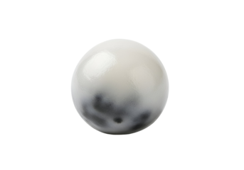 A glossy, round, off-white object with dark gray speckled patterns is highlighted against a pure black background.