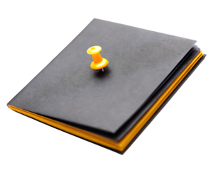 Notebook with yellow push pin on white background isolated on a transparent background