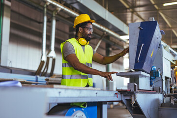 Worker Operating Machinery in an Industrial Factory Setting with Safety Gear