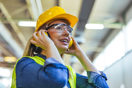 Female Factory Worker Wearing Safety Gear in an Industrial Setting