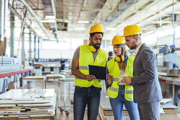 Team Collaboration in Modern Industrial Workspace with Safety Gear