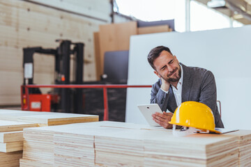 Architect Reviewing Project Plans While Experiencing Neck Fatigue at Construction Site