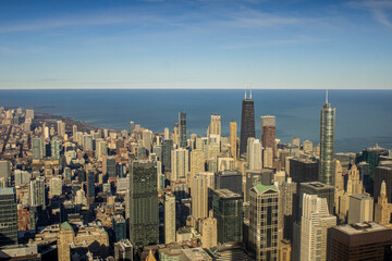 City skyline over water with high-rise buildings under blue sky