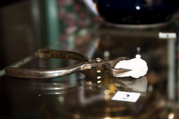 Old scissors and sugar on a glass table. Selective focus.