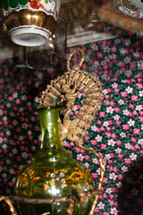 Traditional moroccan glass vase with floral ornament on the table
