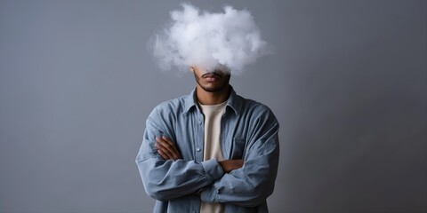 Male with cloud obscuring face in denim shirt against gray background