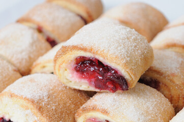 Freshly baked buns with jam and sugar on a white background. Baked in the oven.