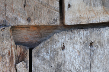 Old wooden texture background. Close-up of old wooden planks. The planks are nailed together with nails.