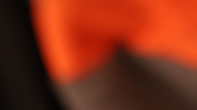 Fiery red-orange glow melting into dark shadowed canvas, abstract blurred gradient with warm upper tones and moody black fade