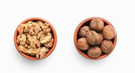 Bowls of peeled and unpeeled walnuts isolated on white background, top view