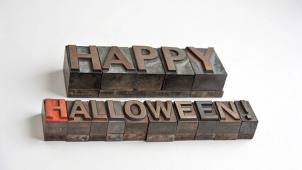 Vintage letterpress type blocks spelling out happy halloween isolated on white background, perfect for a retro and festive holiday greeting