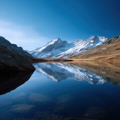 Obraz premium lake surrounded by snow-capped peaks, reflection of mountains in water