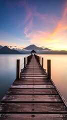 Fototapeta premium Peaceful wooden pier leading to a serene sunrise over a lake