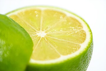 Fresh Lime Slices with Water Droplets on White Background
