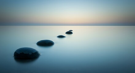 Stone Pathway to Serenity: A tranquil path of smooth stones extends into a serene expanse of calm water, disappearing towards a soft horizon. It evokes a sense of peace, journey, and reflection.
