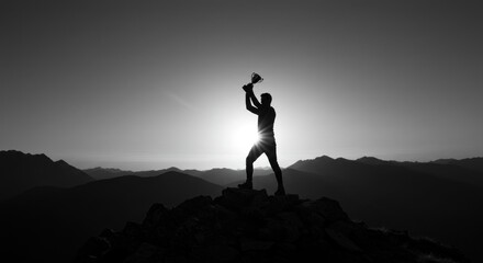 Silhouetted figure victoriously raises a hammer atop a mountain peak at sunrise.