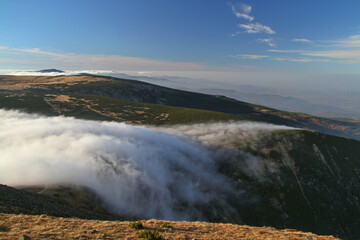 Autumn is coming: Cloud flowing over the pass (Obri sedlo) in Krkonose mountains, Czech Republic/Poland