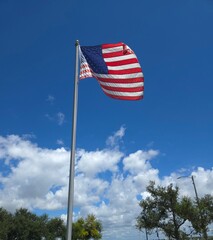 American flag waving in blue sky with clouds Bradenton FL  8/20/2025