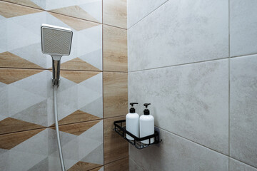 This contemporary shower space features elegant tiles that enhance the aesthetic appeal and...