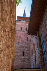 Historic Arap Mosque tower with brick architecture, Ottoman minaret, archway, windows and sky view in Karaköy Istanbul, ancient Islamic heritage landmark