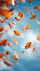 Experience the spirit of fall with orange leaves fluttering in the breeze beneath a luminous sky. An ideal visual for celebrating nature, seasonal change, and the vibrant beauty that autumn brings to
