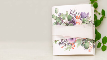 Elegant Wedding Invitation Mockup Showcasing Beautiful Floral Design and Soft Ribbon Detail