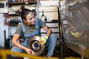 A young mechanic carefully installing a brake rotor, exemplifying precision and skill in automotive repair work.