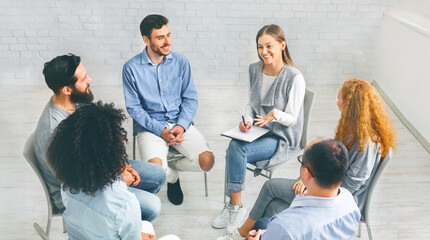 Psychological support group. Diverse happy people sitting in trust circle on therapy session, discussing their achievement in recovery