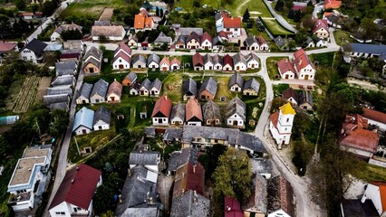 Traditional village houses with church from aerial view
