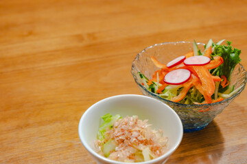 Japanese appetizer with fresh vegetable salad and small side dish
