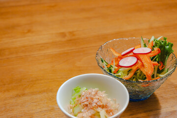 Japanese appetizer with fresh vegetable salad and small side dish

