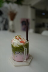 A glass of iced tea with whipped cream