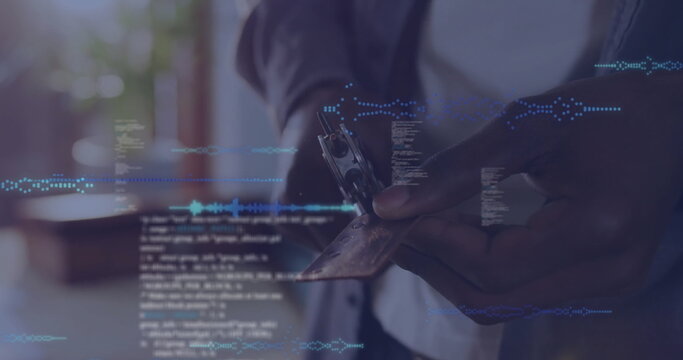 Holding credit card with reader, technician wearing blazer at home office window, code overlay - Powered by Adobe