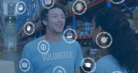 Reviewing male volunteer scanning boxes in warehouse aisle, with digital overlay icons, copy space